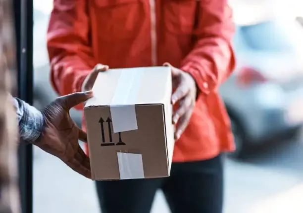 Courier handing over a parcel at the door